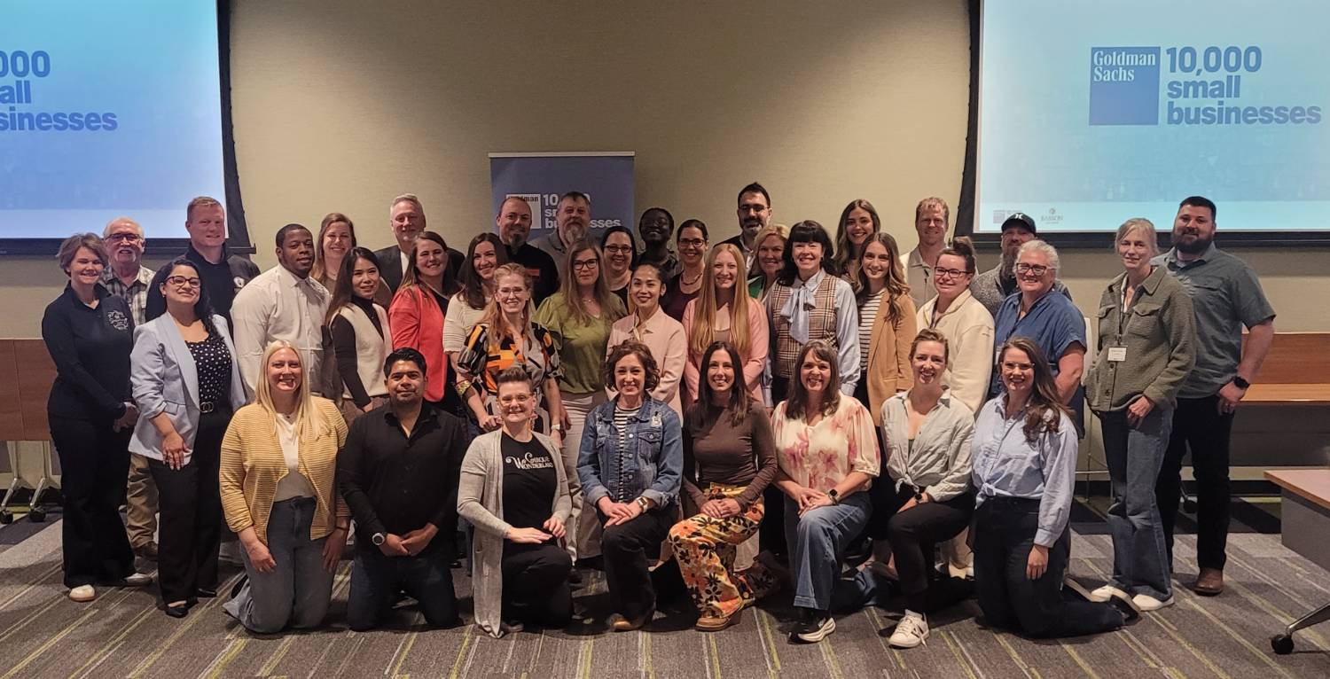 Posed group of 38 people standing in four rows with 