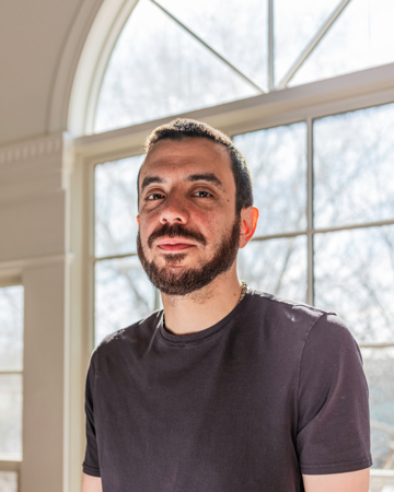 Headshot photo of writer and professor Kaveh Akbar